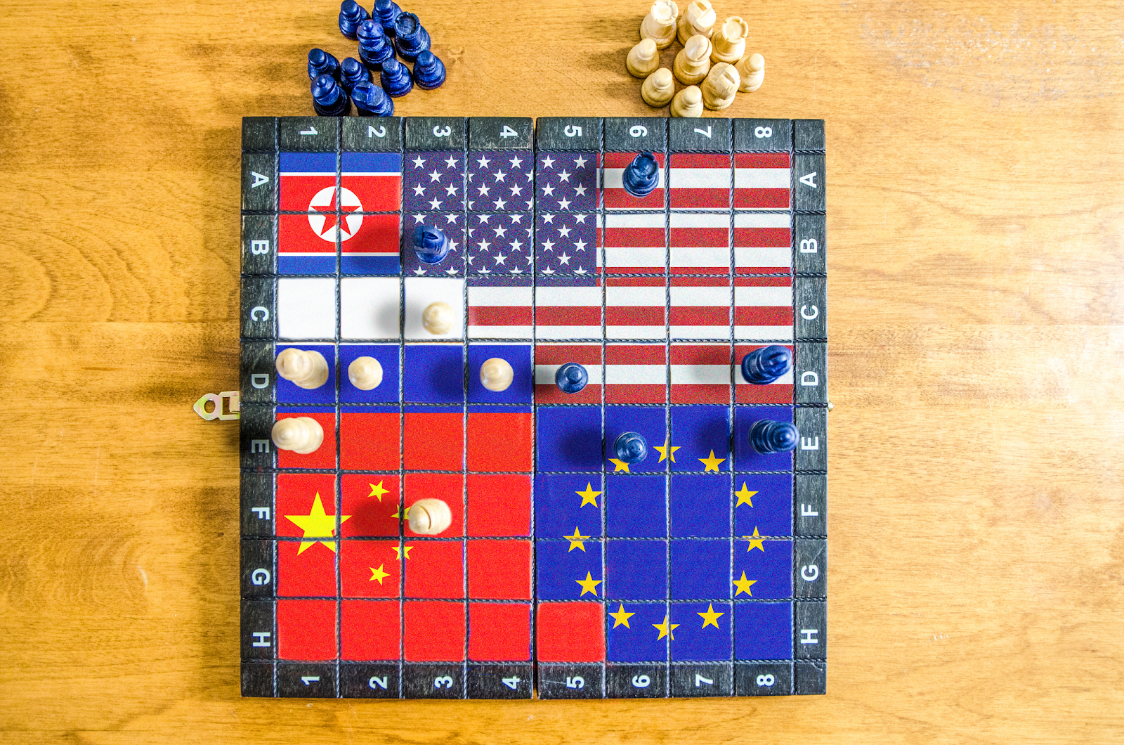 A board game with flags and pieces on it

Description automatically generated