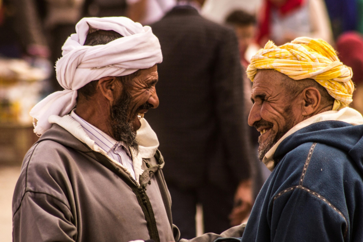 Two men wearing turbans and smiling

Description automatically generated