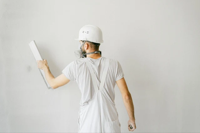 man painting white wall