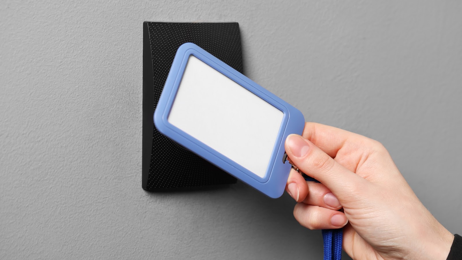 A person using an electronic key card for building entry