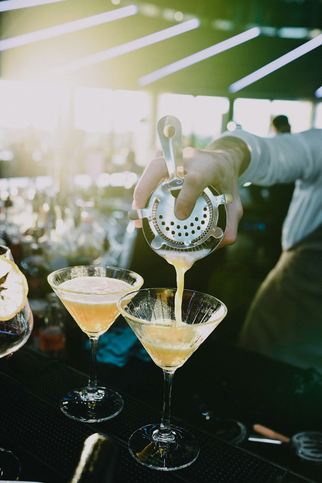 Bartender mixing a signature cocktail at a wedding