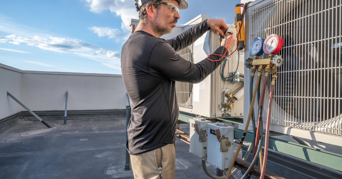 A person wearing a hard hat and black shirt

Description automatically generated