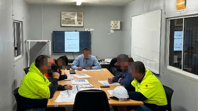 A group of people sitting around a table

Description automatically generated