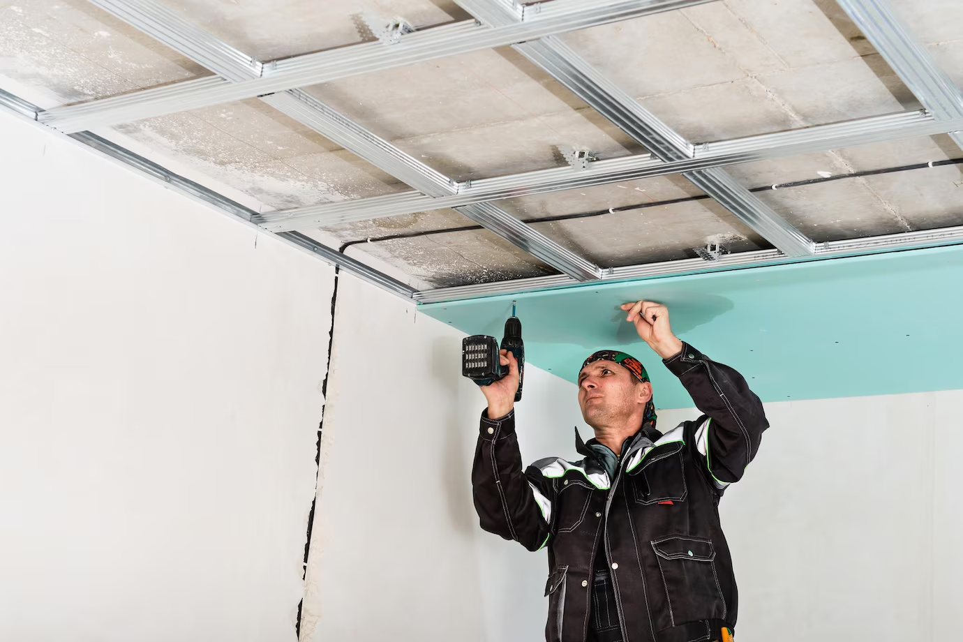 a construction worker installing a suspended ceiling