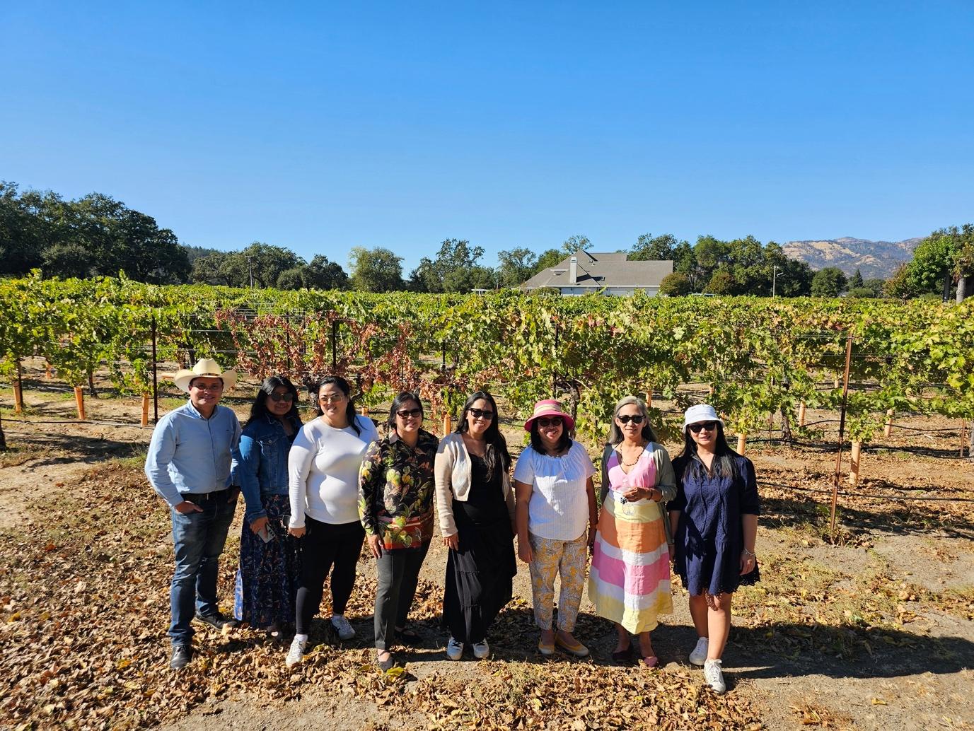 A group of people posing for a photo

Description automatically generated