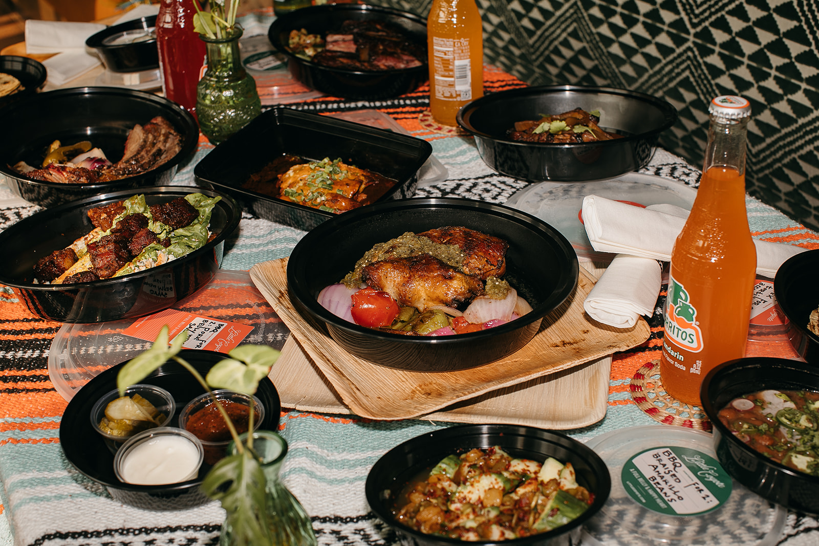 Takeout dishes from Little Coyote in Chattanooga TN, one of the best restaurants in the city, featuring wood-grilled meats, seasonal sides, and housemade sauces