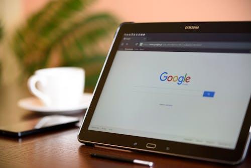 Free Samsung tablet on desk showing Google homepage, perfect for technology-related content. Stock Photo