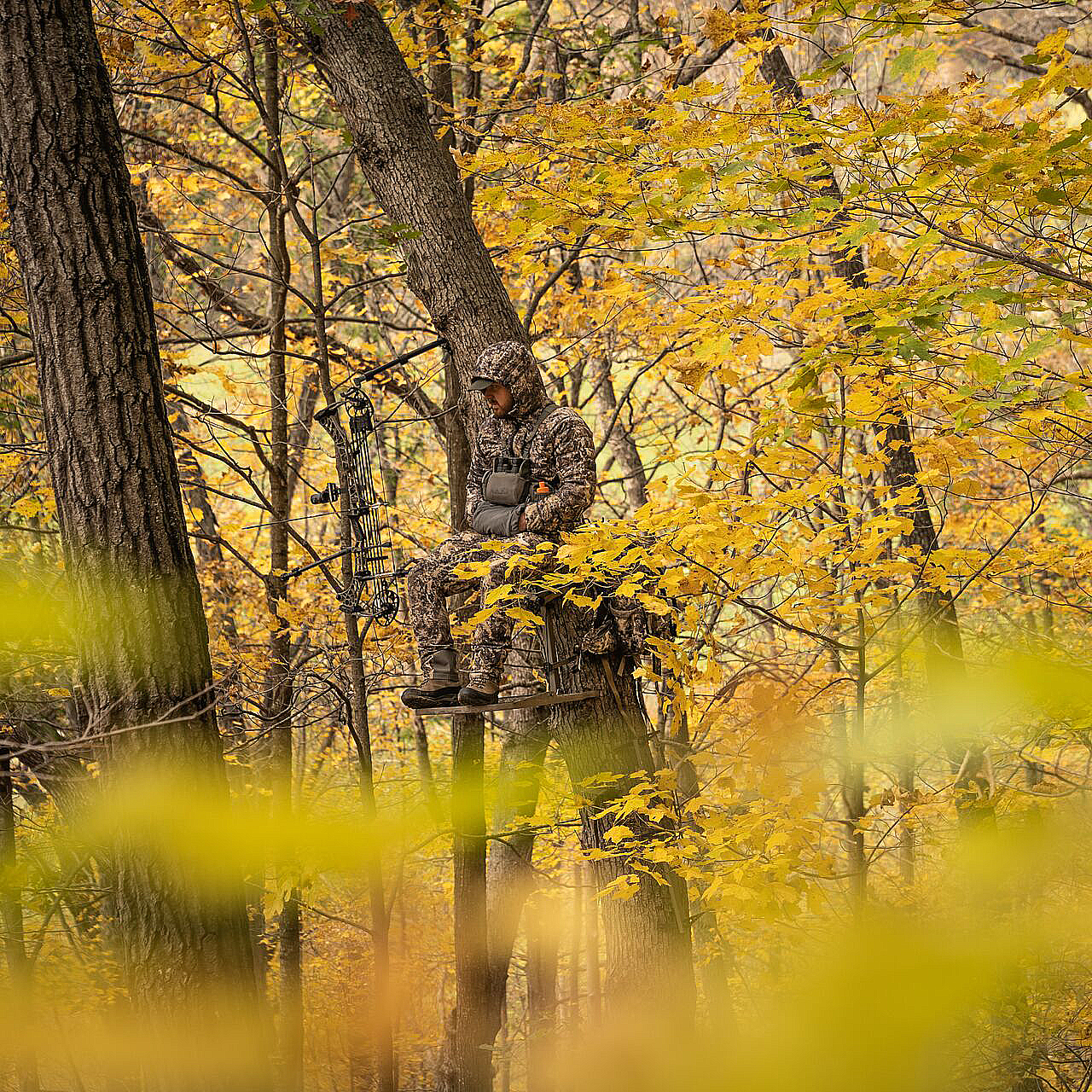 hunter waiting for its prey while having his hands inside the Eberlestock Recon Handwarmer