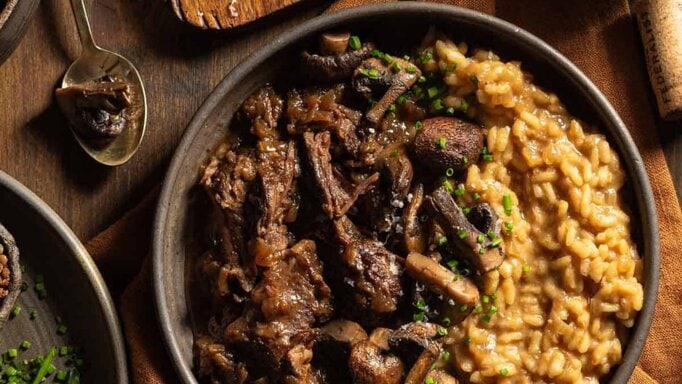 Braised Short Rib Risotto with Mushrooms in a big brown bowl.