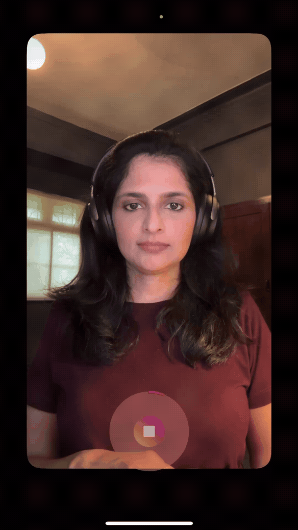 Animated screen recording showing a woman with long dark hair wearing headphones using Instagram Stories hands-free feature