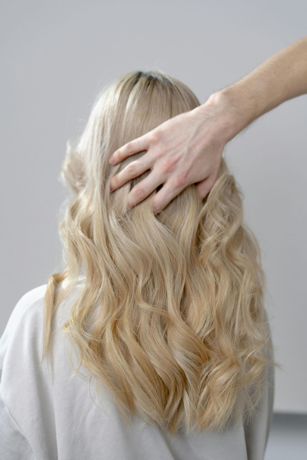 A lady with ash blonde balayage/ombré hair