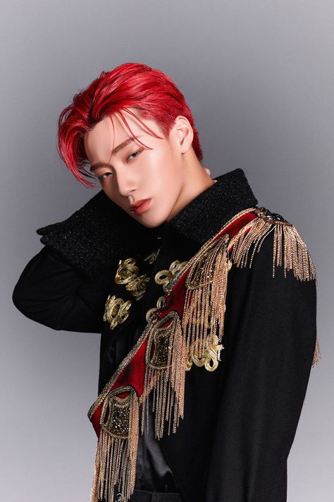 This  contain an image of  San E with red hair wearing a black jacket and gold fringe trimmings