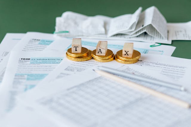word TAX spelled out in blocks over paper