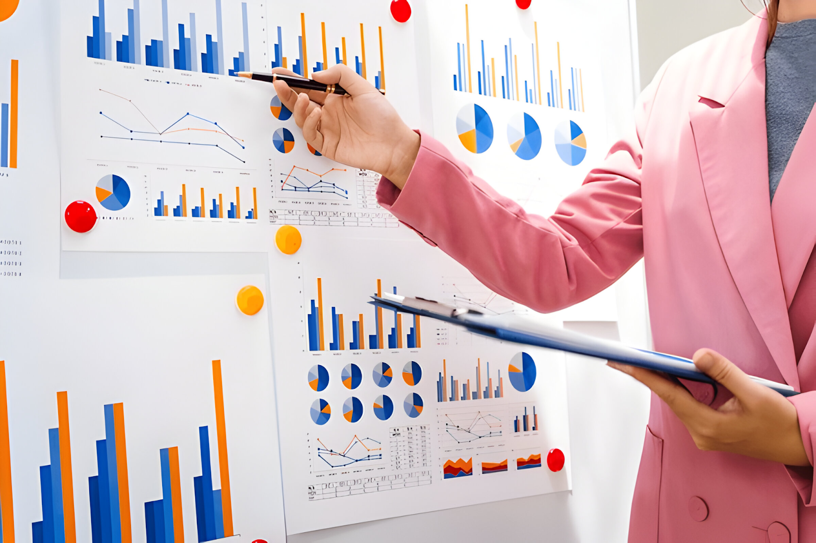 An accountant conducting financial due diligence by analyzing charts and graphs, highlighting the role of accounting in ensuring accurate financial assessments during mergers and acquisitions.