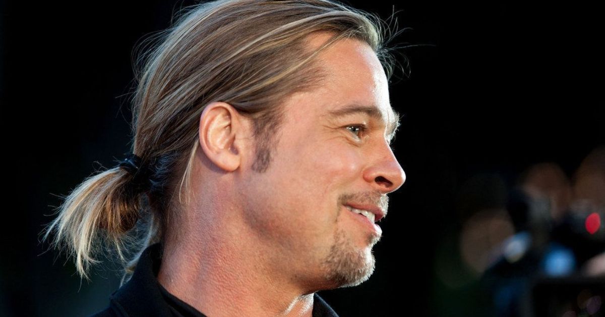 A disheveled Brad Pitt showcasing a messy hairstyle, exemplifying the casual charm of a men's ponytail.