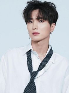 This is a picture of Leeteuk wearing a white shirt with a black necktie 