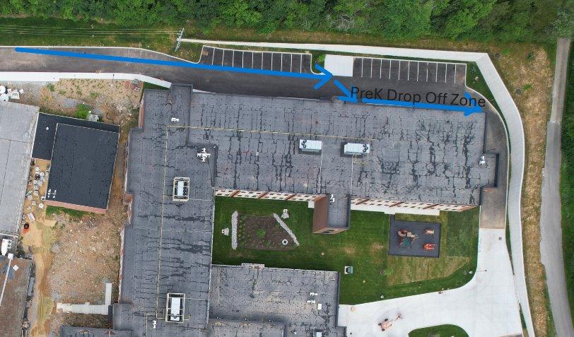 A building with a parking lot and trees AI-generated content may be incorrect.