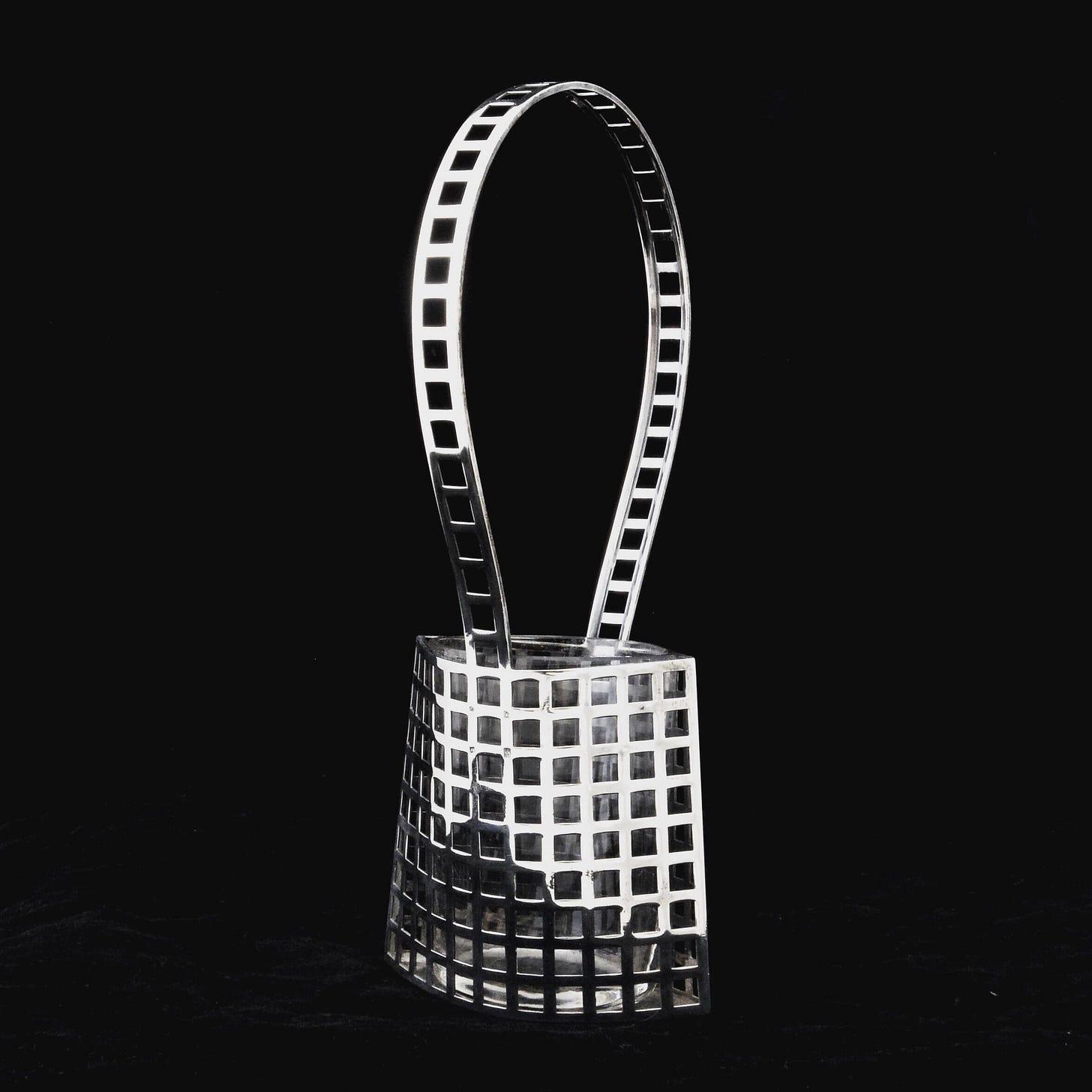 A silver basket with a handle

AI-generated content may be incorrect.