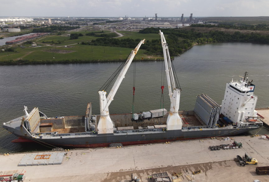 A large ship with cranes on the side of it

Description automatically generated