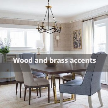 A dining table with gray chairs, wood and brass accents