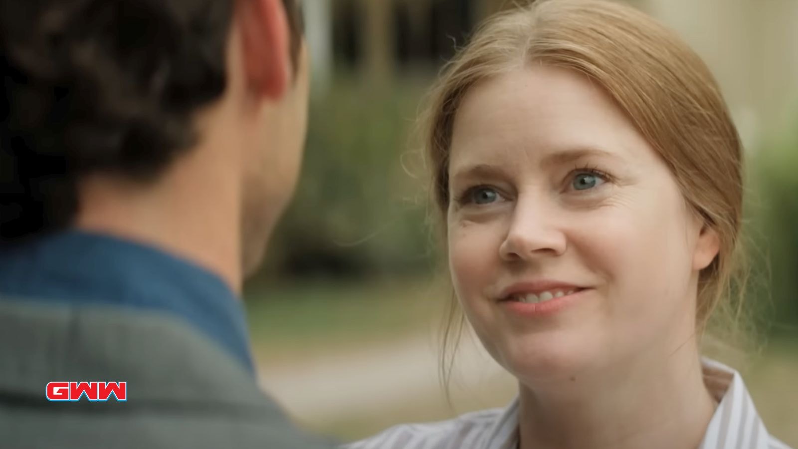 Amy Adams as the main character, smiling during an interaction.