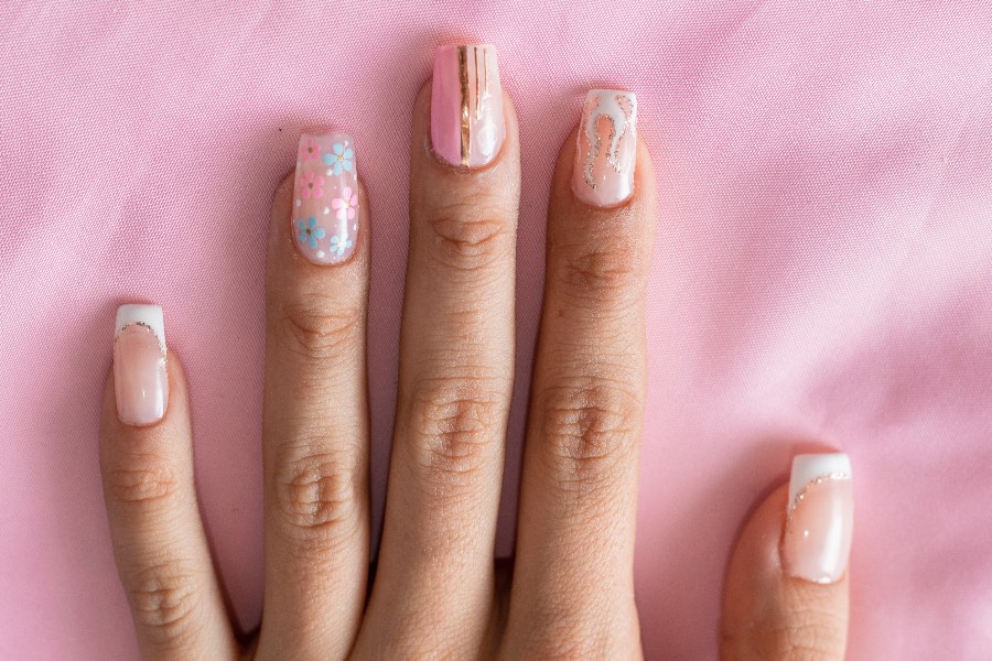 Abstract art details make each French nail tip design a unique statement.