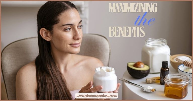 Woman applying coconut butter to hair, with avocado and honey on table.