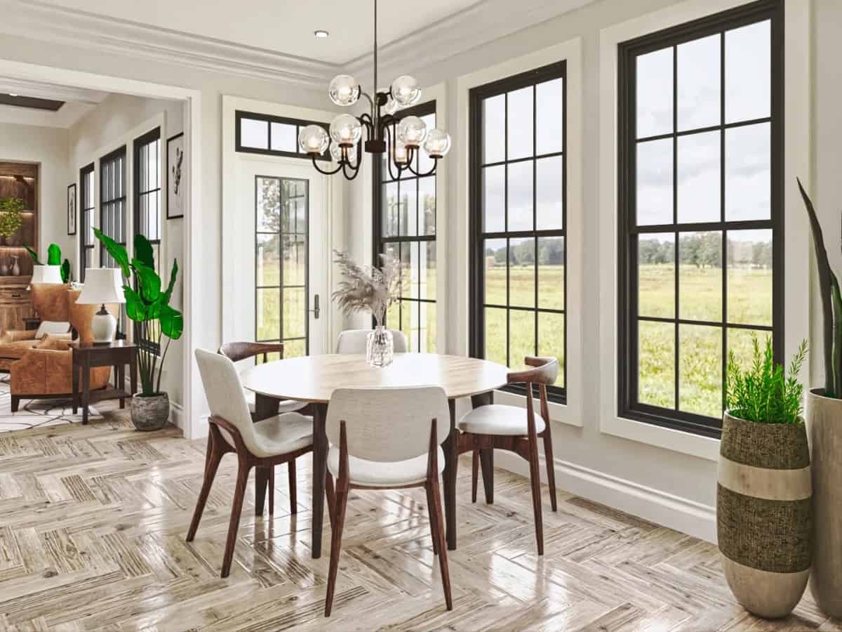 Breakfast nook with a round dining set and direct access to the outdoors through a glazed door.