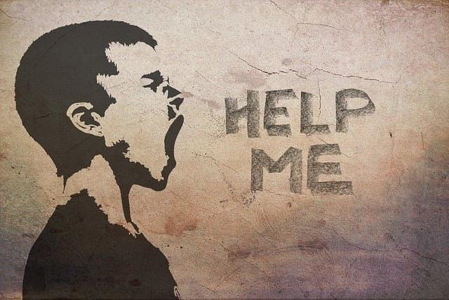 A stencil artwork with a boy screaming Help Me shows concept of getting help for mental illness