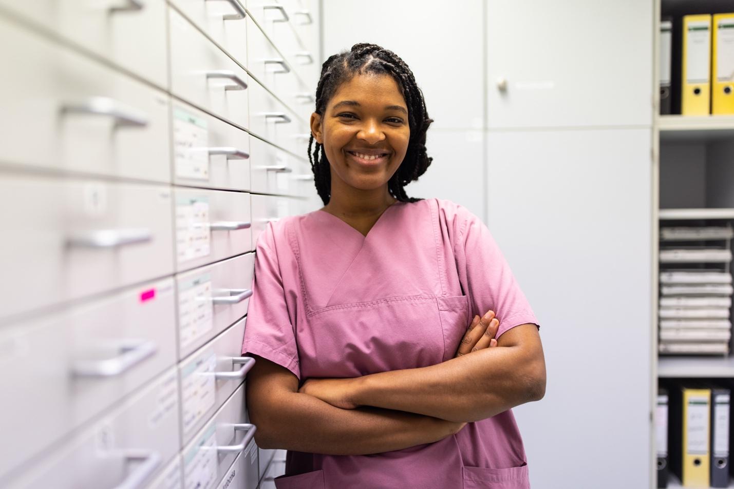 Smiling healthcare worker in pink scrubs