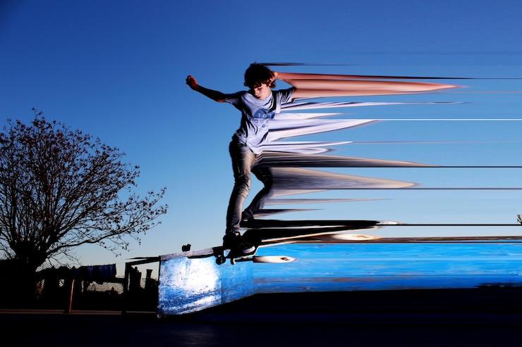Digital composite image of teenage boy skateboarding in mid-air against clear blue sky Mobile Gaming vs PC Gaming Which One Wins in 2025
