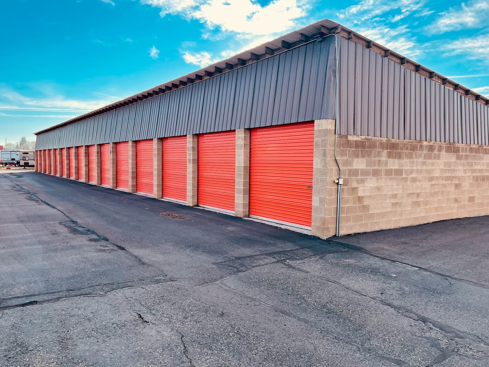 A bank of self-storage units with orange doors