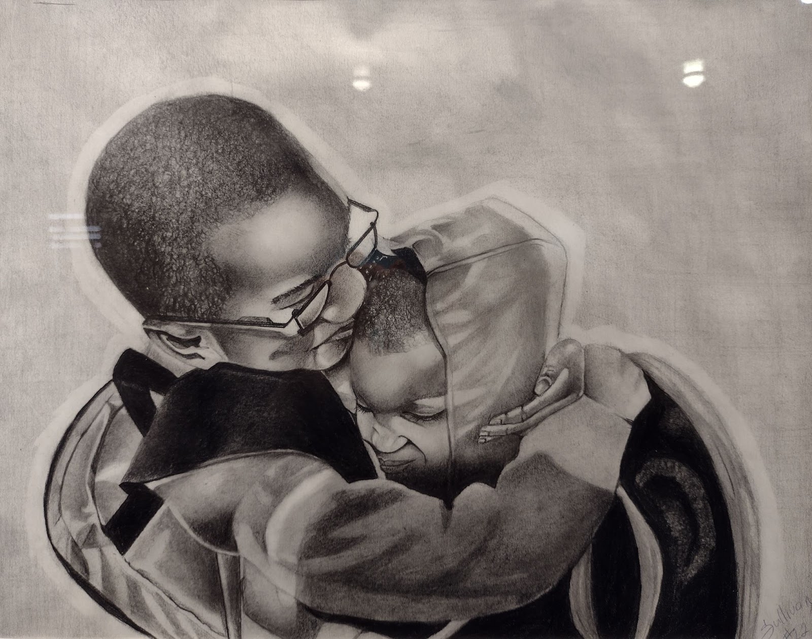 Image: Black Love by Michael Sullivan, 2022. A greyscale image of a Black man and a Black child in embrace. The man wears glasses and the child wears a hoodie. Both have a light smile on their face. Image courtesy of Michael Sullivan.