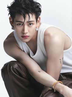 This contains an image of: Got7 bambam wearing a white singlet and a coffe brown trouser 