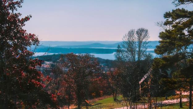 a scenic view of a lake and mountains in the distance