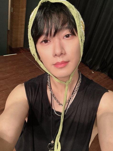 A picture of Minhwan on a black handless singlet 