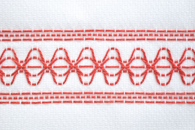 A close-up of a red embroidery

Description automatically generated