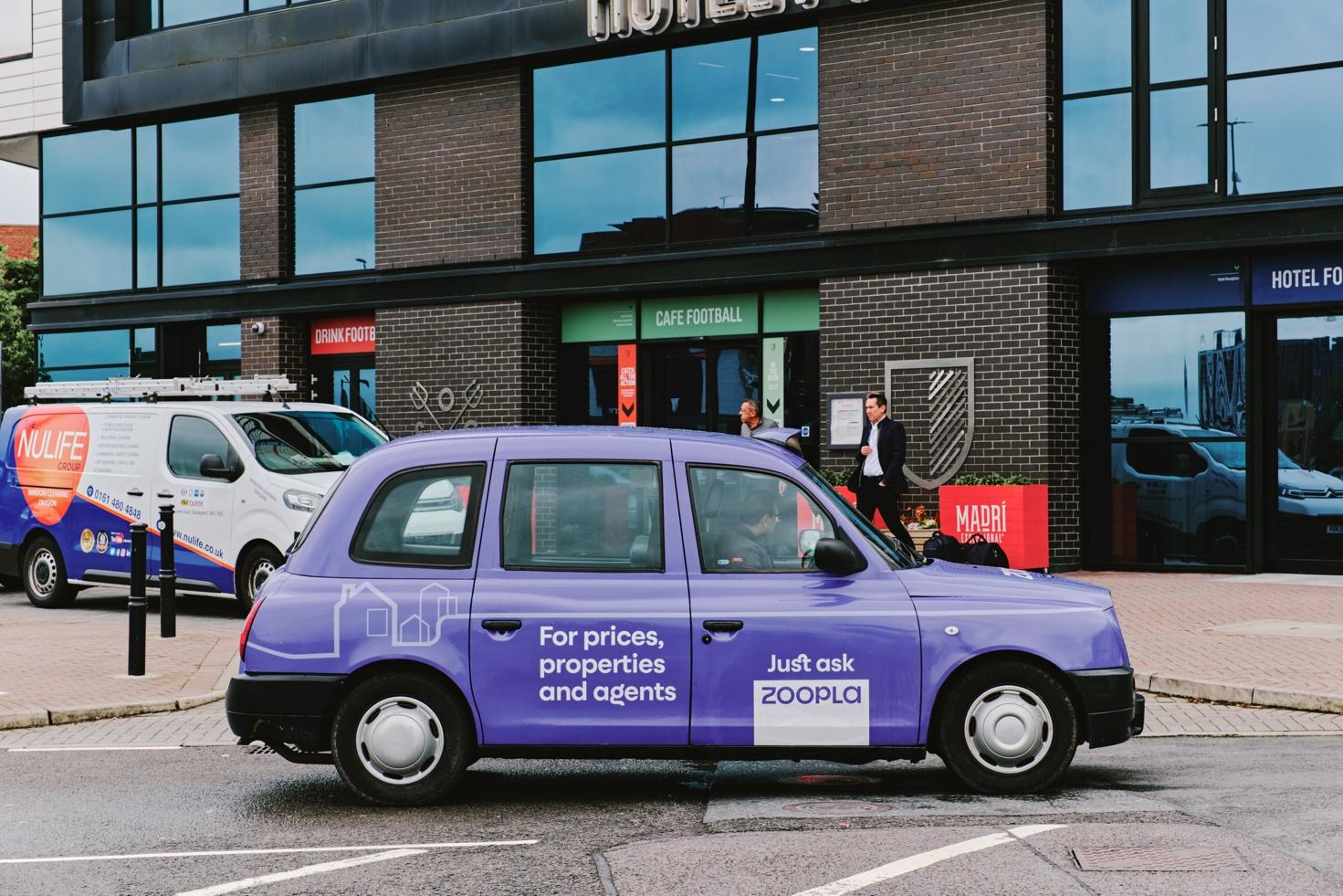 A purple car parked on the street Description automatically generated