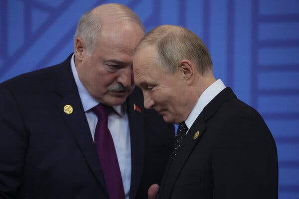 Mr. Lukashenko and President Vladimir V. Putin of Russia, their heads leaned forward in private conversation. Mr. Putin is smiling.