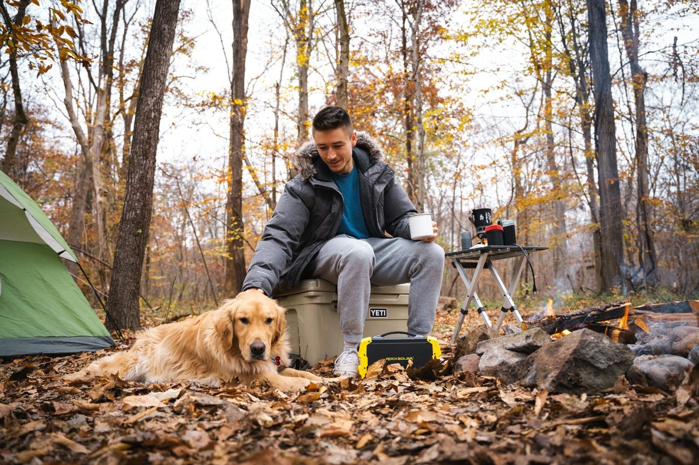 a man sitting in a chair next to a dog