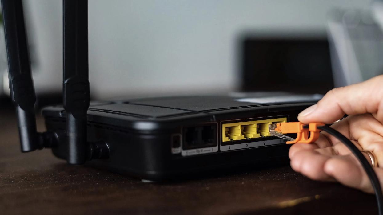 A person plugging in their router