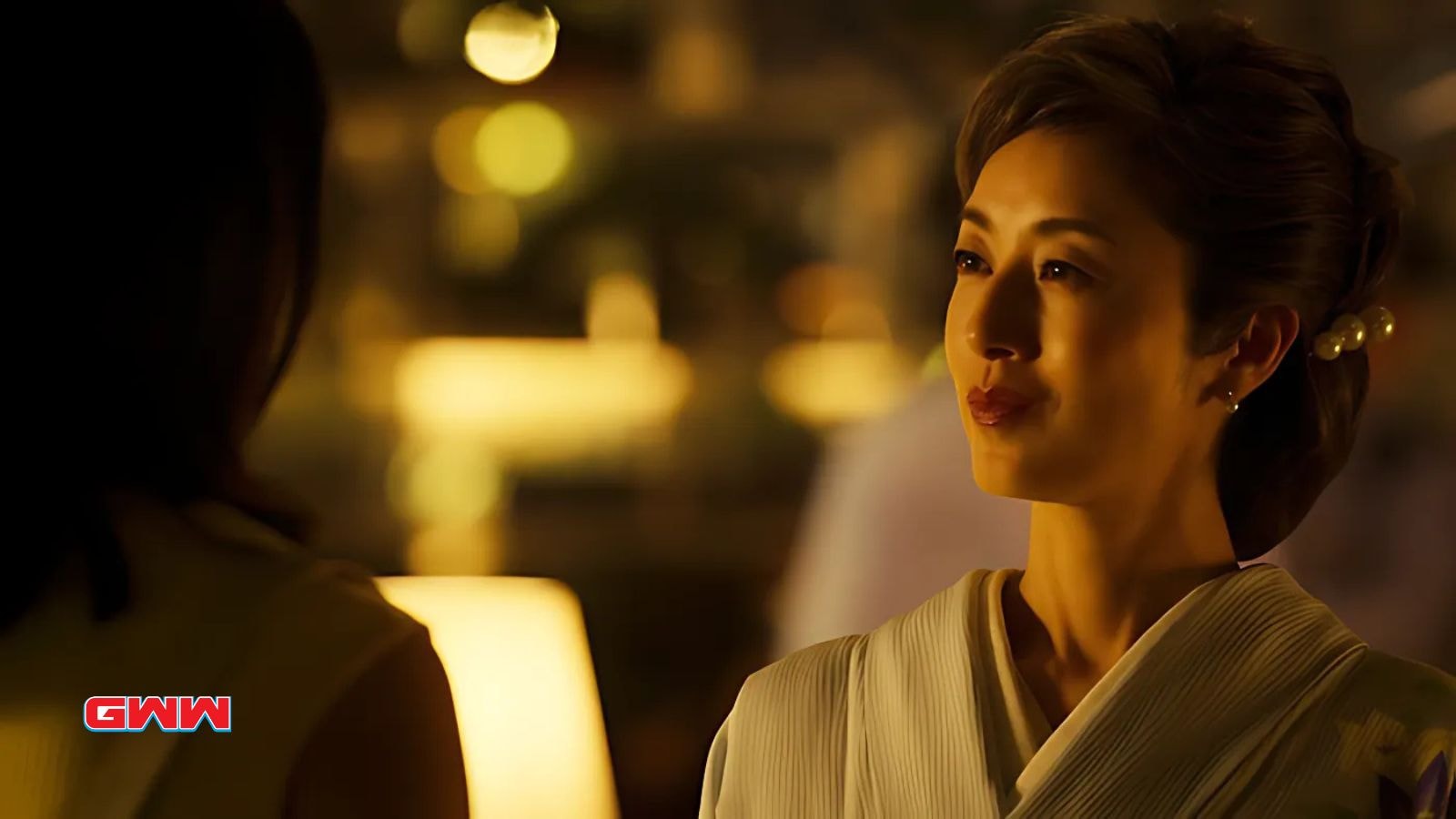 Yumi Kawai as Yumi Sawamura, in traditional attire under soft lighting.