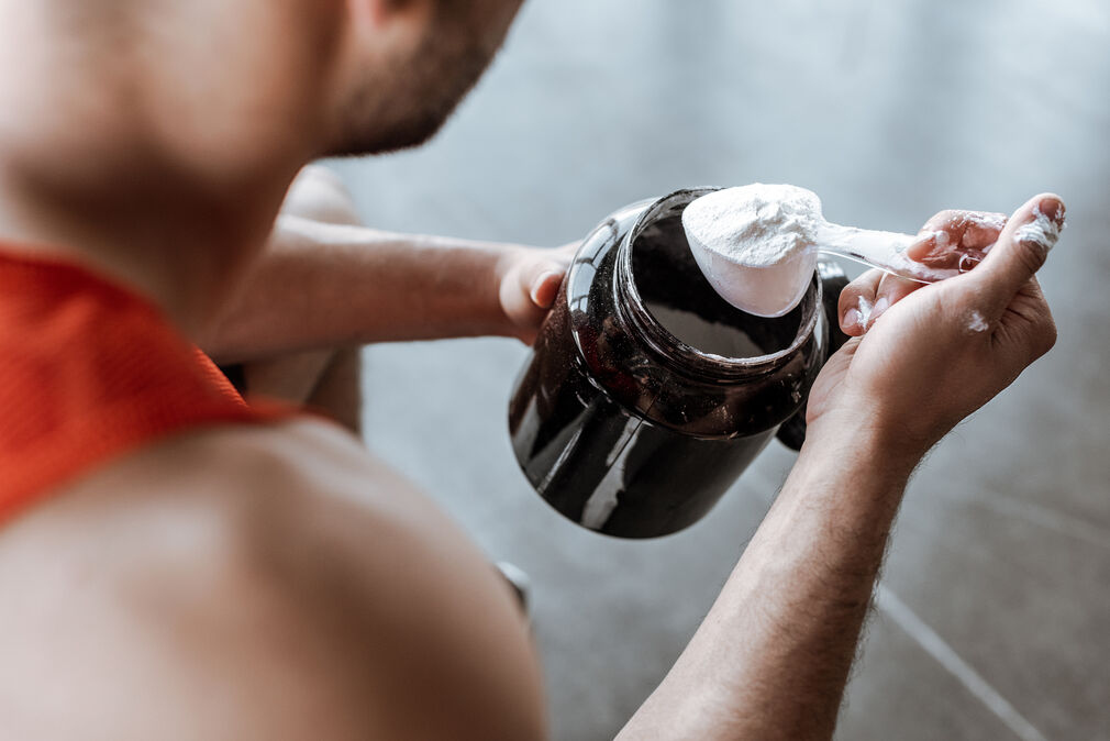 low-caffeine pre-workout - man holding a preworkout