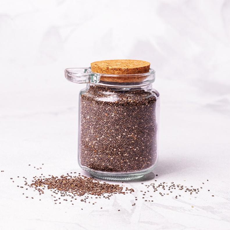 A glass jar with a cork lid and a brown substance

Description automatically generated