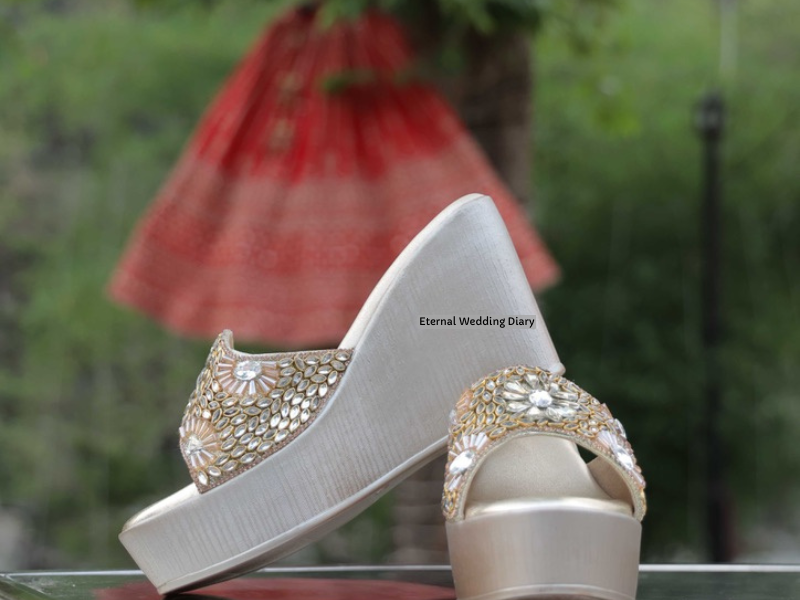 Bridal Wedge Heels with bridal red lehenga in the background