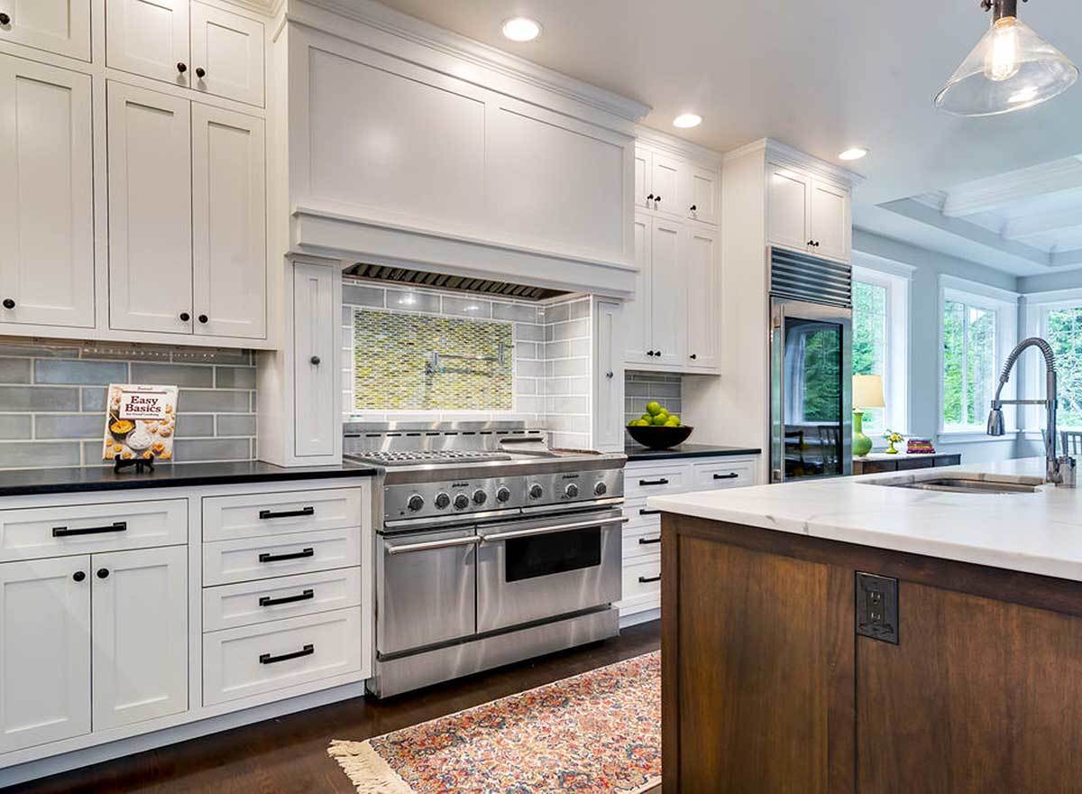 A closer look at the cooking range accentuated with a decorative tile backsplash.