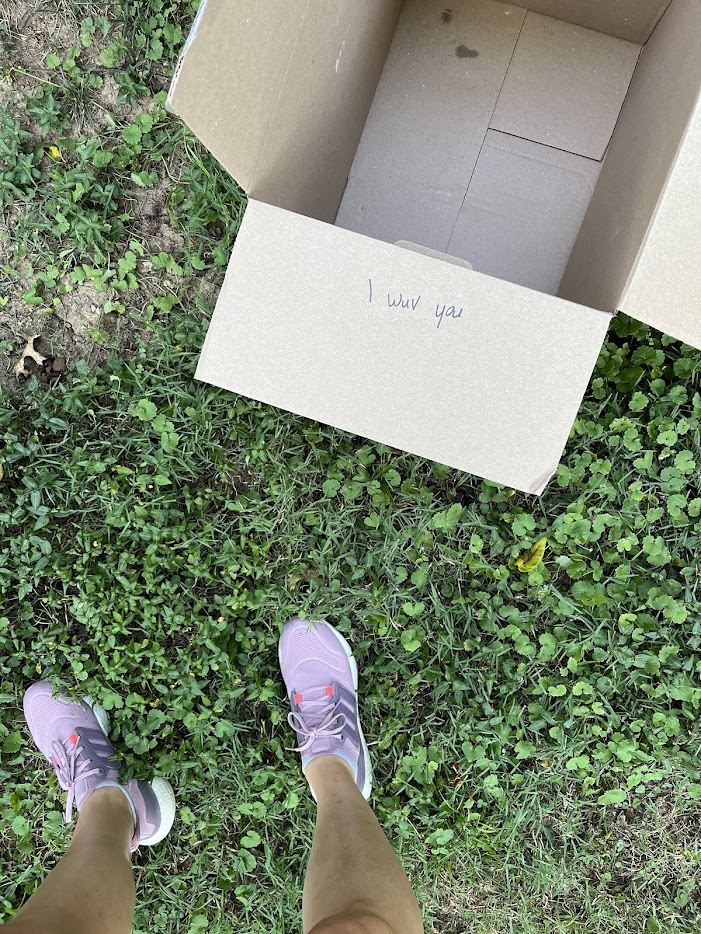 Picture of cardboard moving box with "I wuv you" note written in black marker from Allea's niece 