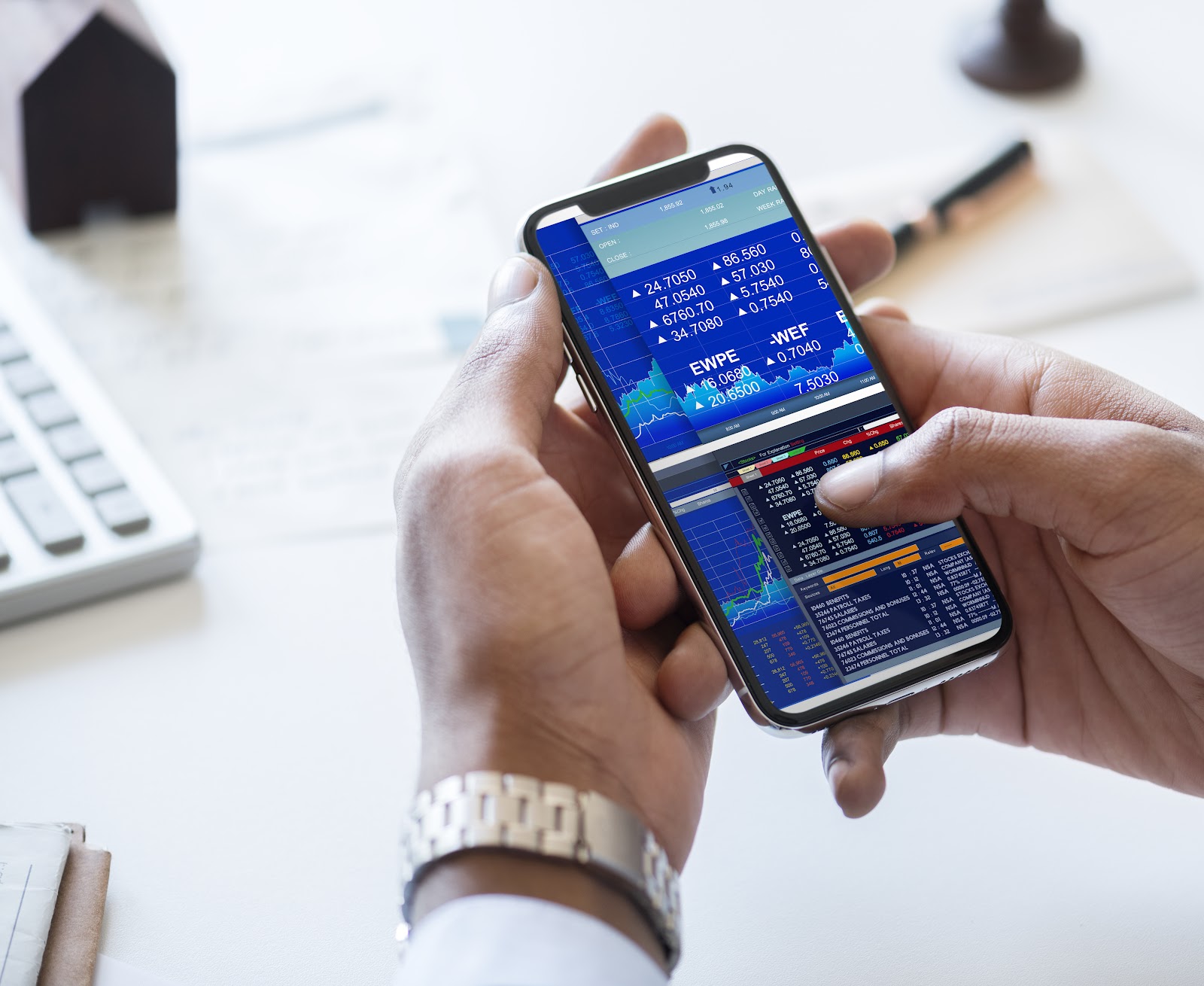 A hand checking the stock market
