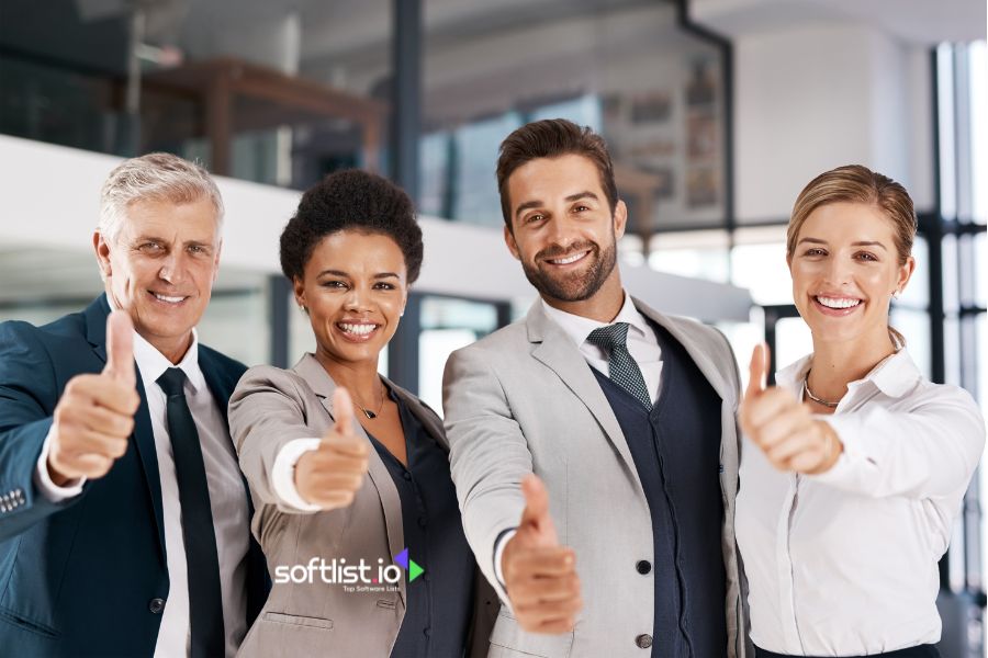 Professional team giving a thumbs-up in an office setting.