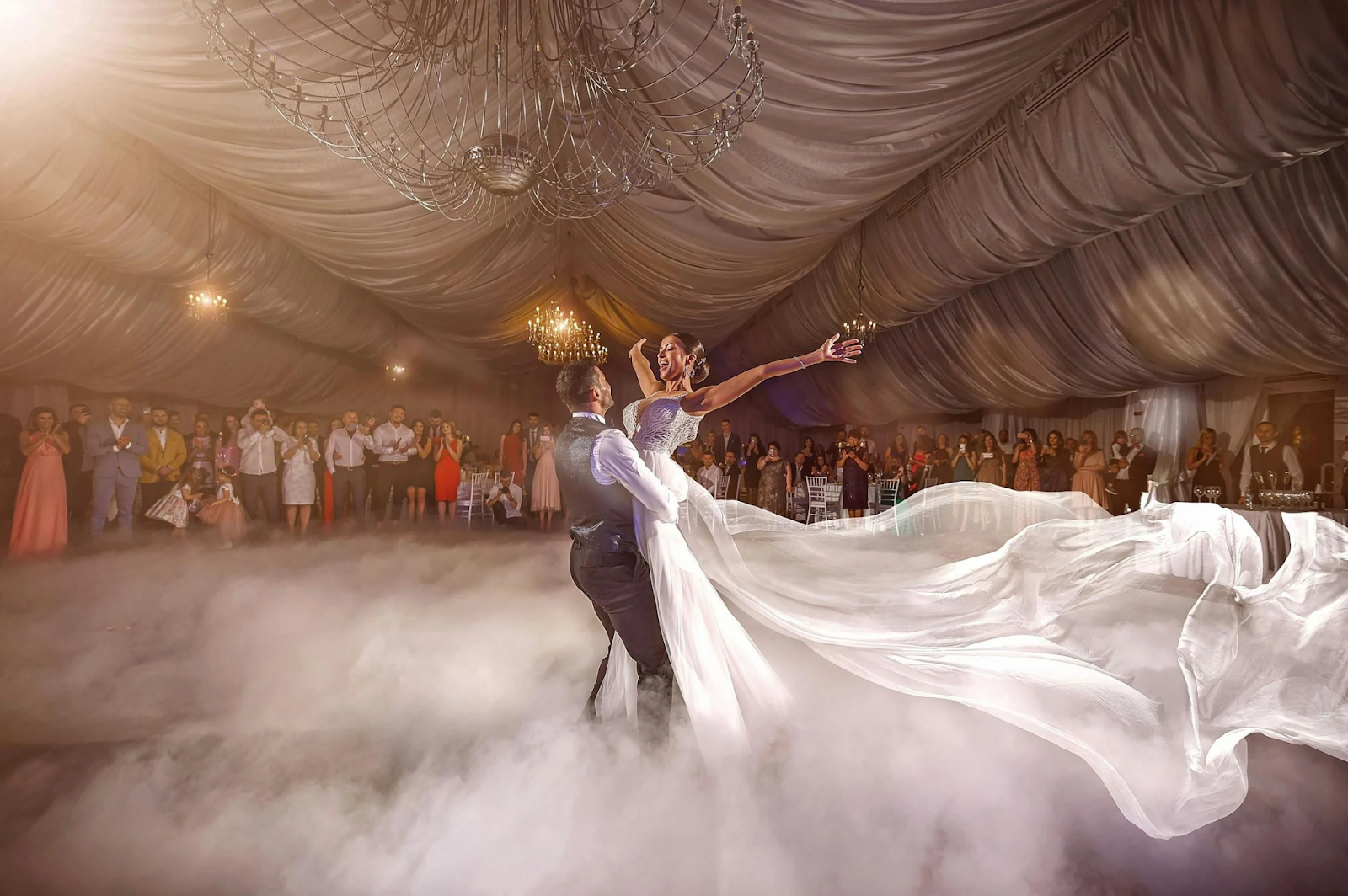 Groom lifting bride during first dance